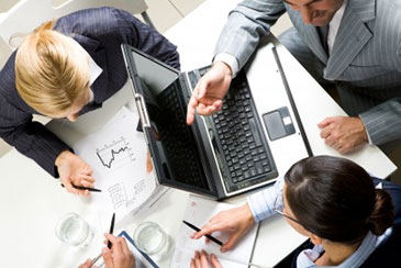 Photo of three people in conference